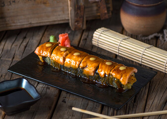 CHIAKI maki served in a dish isolated on wooden background side view