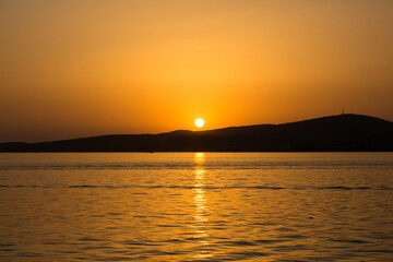 Naklejka premium View of Aegean sea and landscape at sunset captured in Ayvalik area of Turkey in summer.