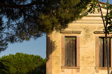 View of old, historical, traditional stone house reflecting Aegean, Mediterranean architectural style captured in Ayvalik, Turkey. It is a sunny summer evening.