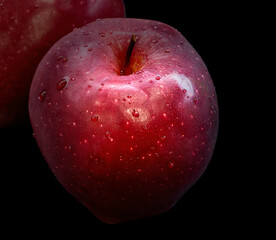 the fruit of a red apple lies on a dark background, still life
