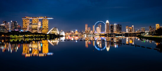 Singapore city skyline with modern skyscraper architecture building for concept of financial business and travel in Asia cityscape urban landmark, marina bay at night district dusk sky