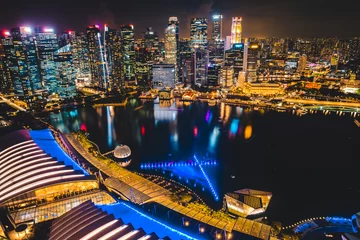 Fotobehang Singapore city skyline with modern skyscraper architecture building for concept of financial business and travel in Asia cityscape urban landmark, marina bay at night district dusk sky © chokniti