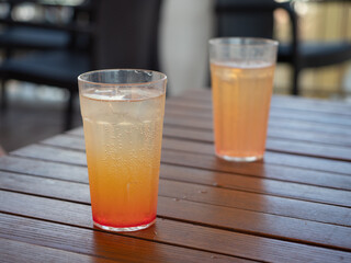 Dwa pomarańczowe drinki na stoliku hotelowym  - obrazy, fototapety, plakaty