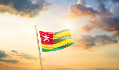Togo national flag cloth fabric waving on the sky - Image