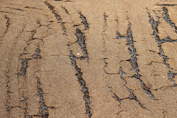Old foot path surface with claw style scratches. Worn out side walk.