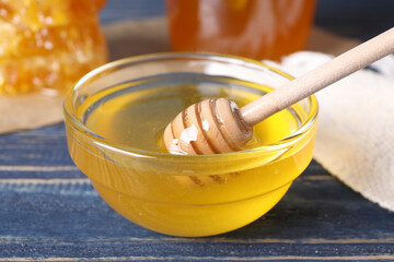 Tasty fresh honey on blue wooden table