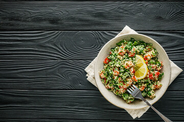arabic salad tabbouleh on a black rustic wooden background