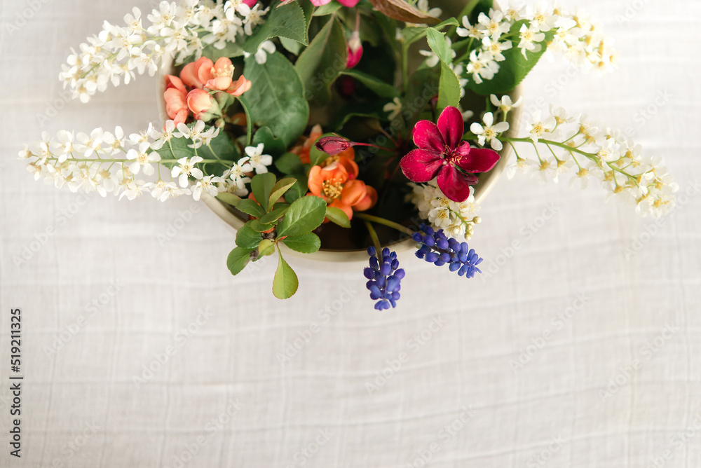 Canvas Prints Summer blooming delicate flowers in a round vase on a table with a white tablecloth, a pastel bouquet and a delicate floral card