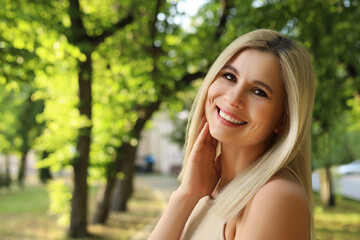 Portrait of beautiful woman outdoors on sunny day, space for text