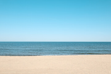 Fototapeta na wymiar Picturesque view of sandy beach with seagulls near sea