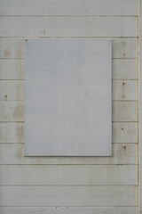 Blank panel on white painted wooden wall