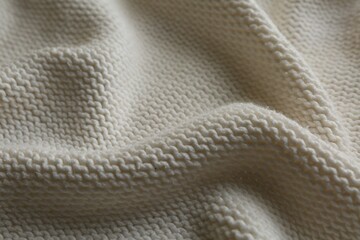 Beautiful white knitted fabric as background, closeup