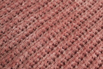 Beautiful pink knitted fabric as background, closeup