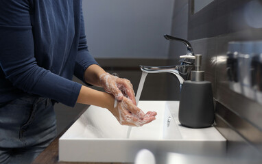 Fototapeta na wymiar Woman washing hands in bathroom, closeup view