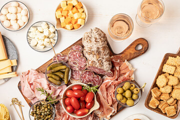 Obraz na płótnie Canvas Appetizers table with different antipasti, charcuterie, snacks, cheese. Finger food for buffet party. Traditional french or italian entires. Top view