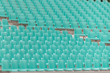 Fototapeta premium rows of plastic empty seats in an outdoor stadium
