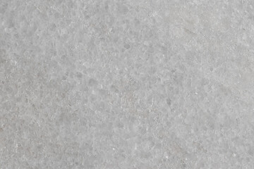 Natural stone tile in light gray color with scratches and marble effect.