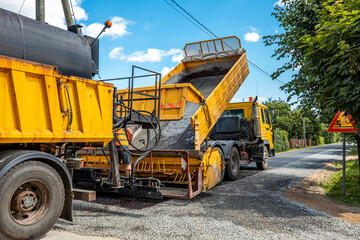 Construction site is laying new asphalt road pavement,road construction workers and road construction machinery scene.