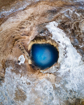 Aerial image of a blue geothermal hot spring pool in Hveravellir Nature Reserve in Iceland
