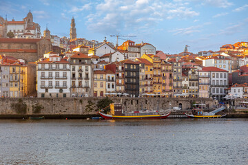 Fototapeta na wymiar City of Oporto, Portugal in the margins of the Douro river. Douro river in the city of Oporto with traditional boats to transport the famous Oporto Wine from the wineries up river