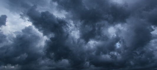 The dark sky with heavy clouds converging and a violent storm before the rain.Bad or moody weather...