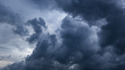 The dark sky with heavy clouds converging and a violent storm before the rain.Bad or moody weather...
