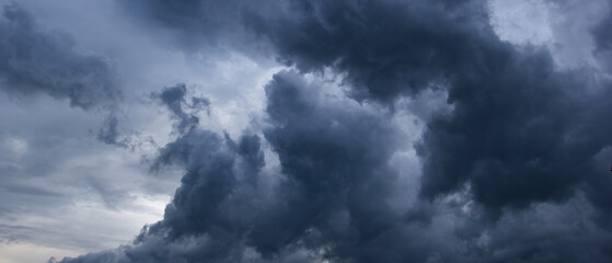 The dark sky with heavy clouds converging and a violent storm before the rain.Bad or moody weather...