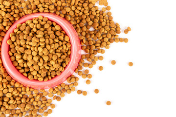 Pink bowl with dry food for a cat (dog) on a white isolated background. Space for text. Balanced nutrition of pets.