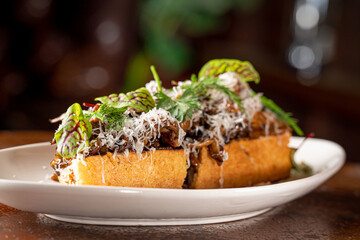 Hen of the Woods Mushroom Toast topped with Greens.