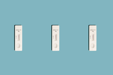 Positive Covid-19 antigen test pattern on light blue background with harsh shadows