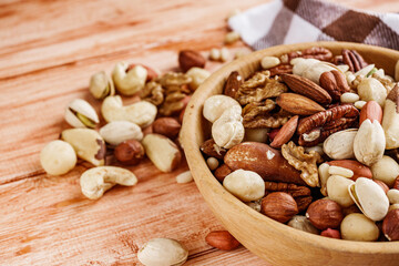 set of different nuts on a wooden rustic background