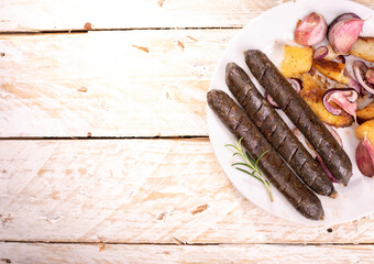 Grilled, roasted vegan sausages. Rustic composition with buckwheat blood sausages on wooden background, top view