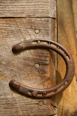 old rusty horseshoe on wooden background