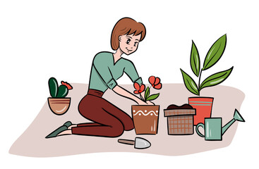 Woman plants flowers at home, sitting on the floor
