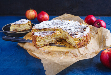Traditional Sicilian apple pie torta di mele cremosa with icing sugar served as close-up on a...