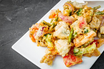 deep fried tempura vegetables on a dark background