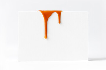 Dripping caramel drops of sweet caramel sauce on white podium on white background.  Melted caramel sauce drip, drops of sweet liquid toffee.