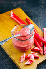 Traditional German rhubarb with homemade rhubarb confiture offered as close-up in a canning jar...