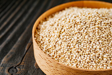white quinoa seeds on a dark rustic background