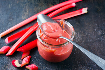 Traditional German rhubarb with homemade rhubarb confiture offered as close-up in a canning jar...