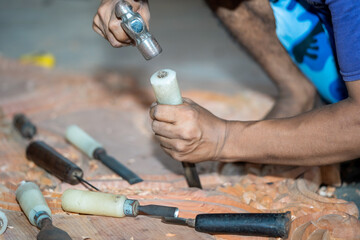 close-up carpenter man's hand treats the tree, cuts the shavings. Copy space. woody curl. Manual processing of wood in the workshop. joiner woodworker in process.
