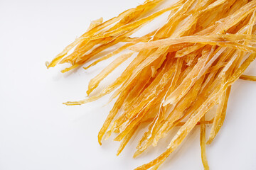 dried fish beer snack on a white acrylic background