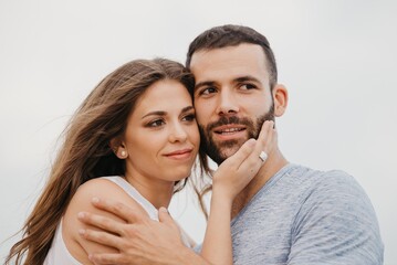 A man and his girlfriend are cuddling up to each other on a rocky hill in Spain