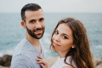 Fototapeta premium A girl is keeping her hands on the shoulder of her boyfriend on the rocky hill