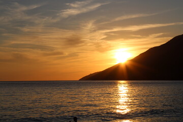 Sunset at the beach with mountain
