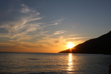 Sunset at the beach with mountain