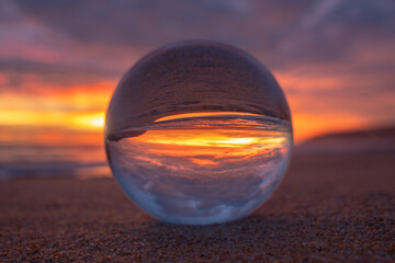 .view of beautiful sky at sunset inside crystal ball..The natural view of the sea and sky in beautiful sunset are unconventional and beautiful inside crystal ball..