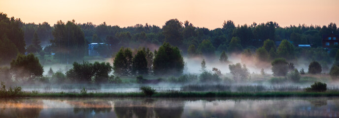 Morning on the river early morning reeds mist fog and water surface on the river. Beautiful natural landscape. Summer travel