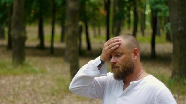 A white man in the park reflects on the meaning of life. existential crisis.