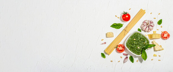 Traditional ingredients for the preparation of classic Italian pasta. Dry spaghetti, basil pesto